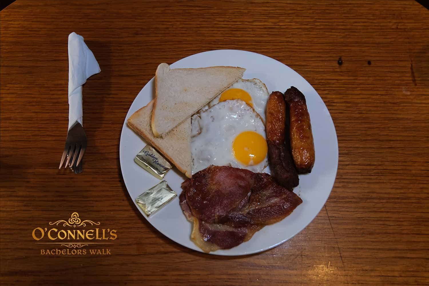 Traditional Irish breakfast with eggs, bacon, sausages, and toast at O'Connell's Bar Dublin.