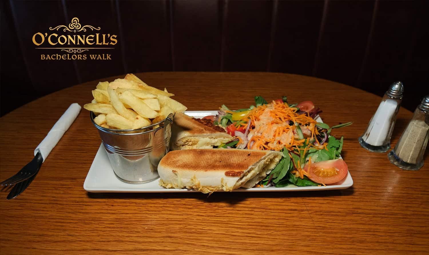 Classic lunch plate with chips, sandwich, and fresh salad at O'Connell's Bar Dublin.