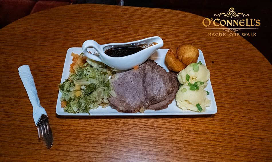 Irish roast dinner with beef, vegetables, gravy, and side dishes at O'Connell's Bar Dublin.